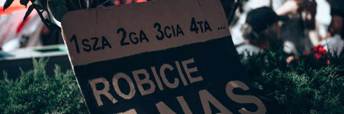 a sign in front of a crowd